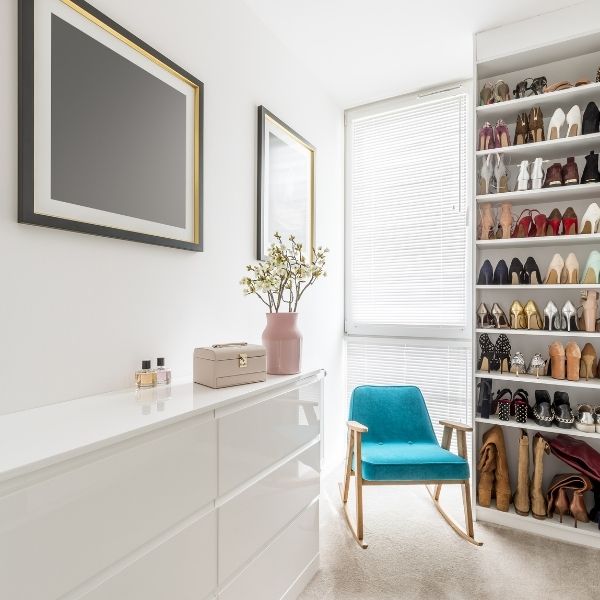 organized closet with dresser and shoes on display